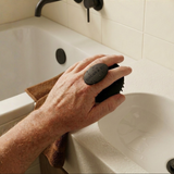 Pet bath massage brush held in hand